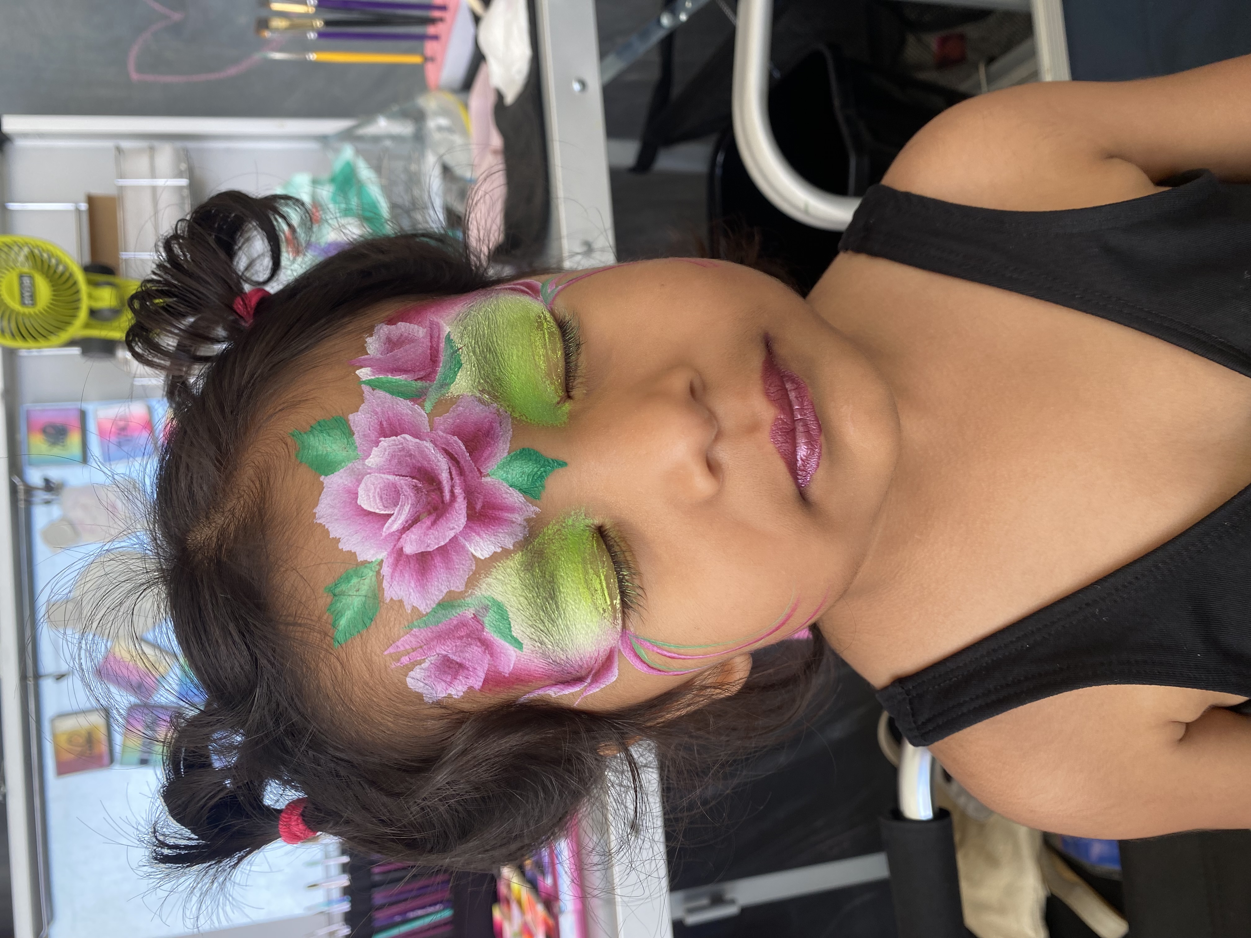 Purple fairy lotus face paint on a girl