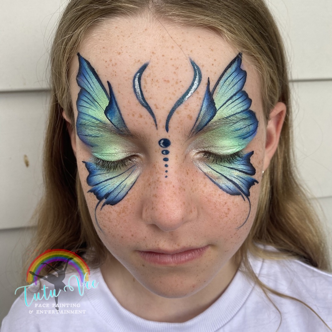Purple pink fairy petals face paint on a girl
